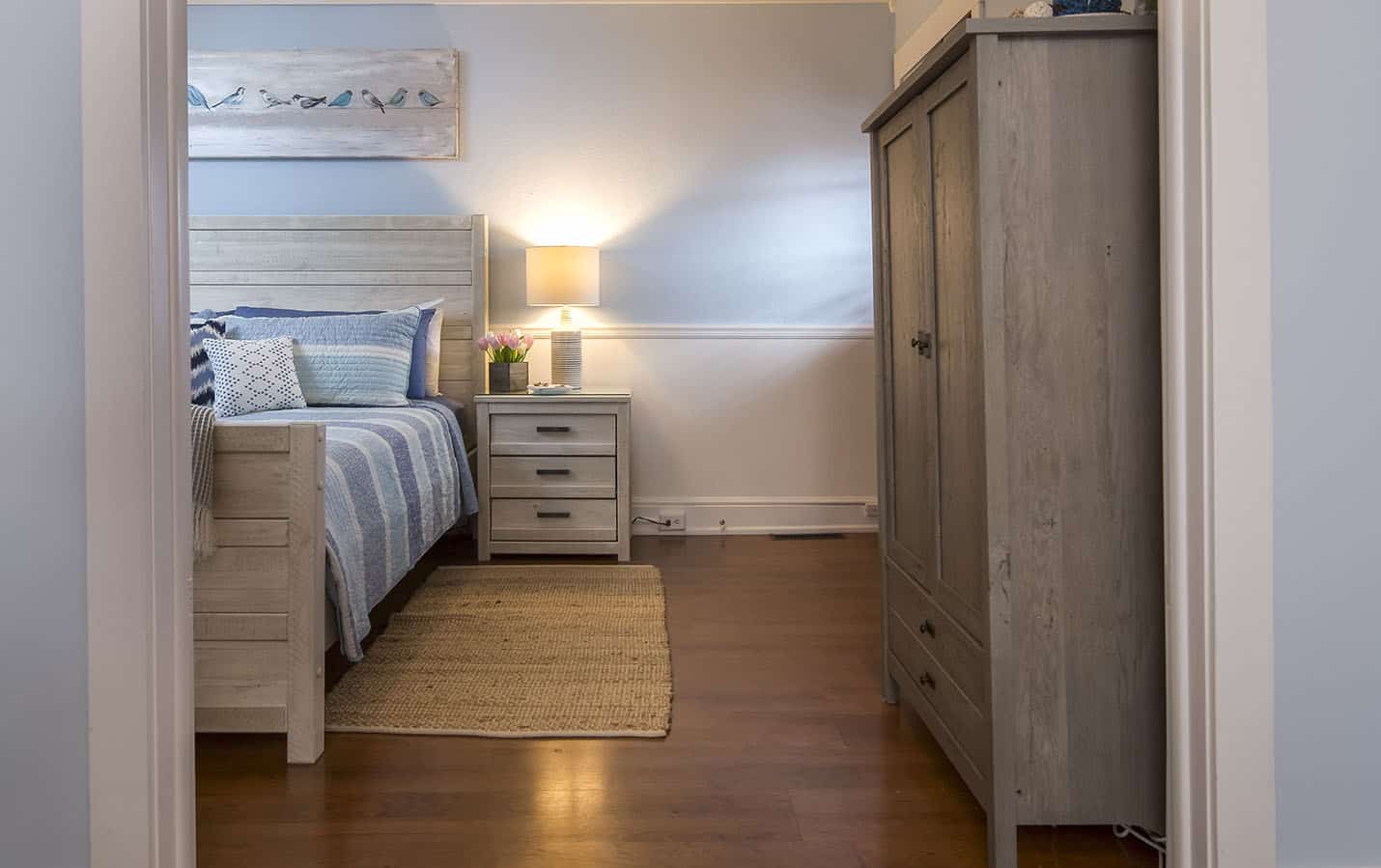 Side of the bed with 3 drawer night stand and freestanding closet