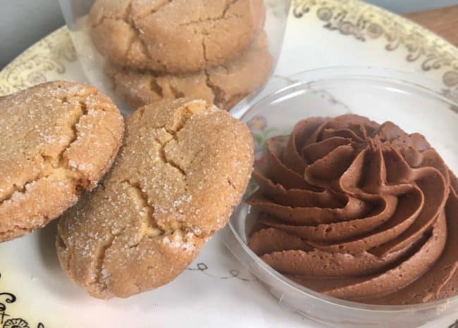 Four brown cookies with chocolate icing