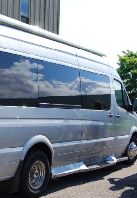 Extra long silver van with dark tinted windows