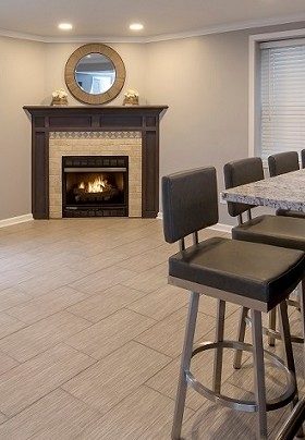 Room with fireplace and bar with three stools