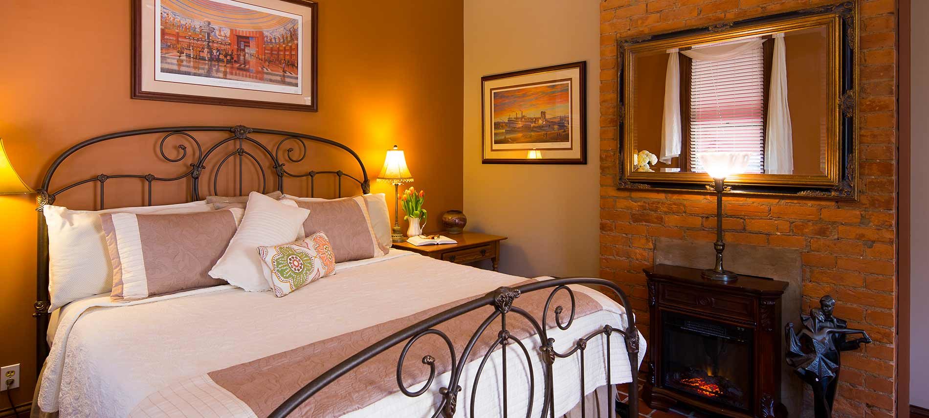 Bedroom with fireplace and large mirror.