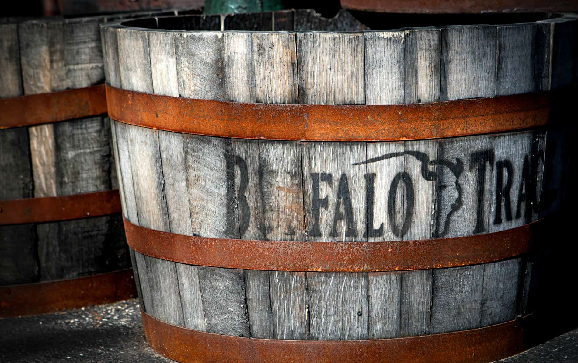 Old gray weathered bourbon barrel with the name Buffalo Trace stenciled on the front