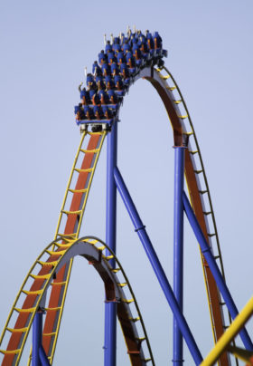 Colorful roller coaster lit by low sunset