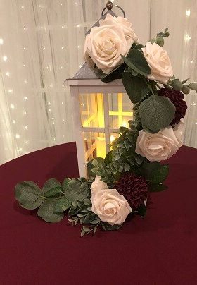 White lantern with white and burgundy roses