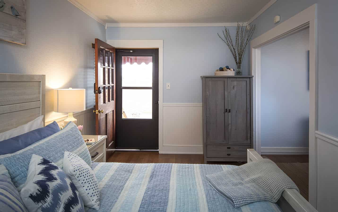 Entry view with layout of the room with bed and freestanding closet